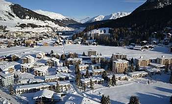 Aerial view of a snow-covered village in the mountains.
