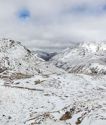 Schneebedeckte Berge und eine Hütte in der Landschaft.