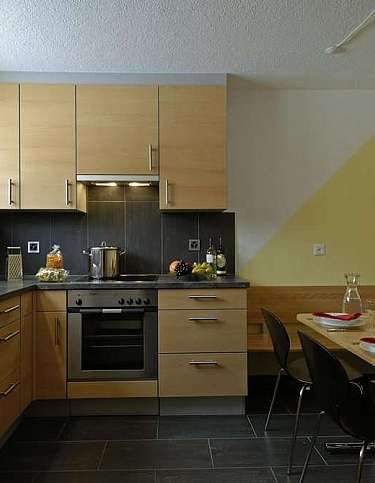 Stylish kitchen with dining table and contemporary decor.