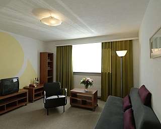 A stylish living room with a sofa, TV, and decorative elements.