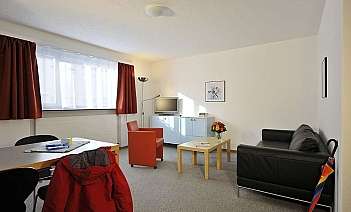 Modern living room interior Bright living room with sofa, table, and decorative flowers.