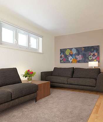 A stylish living room with two sofas and floral artwork.