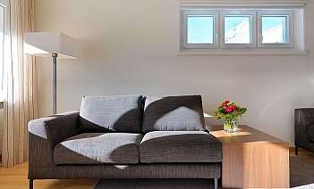 Modern living room setup A stylish sofa and coffee table in a bright room.