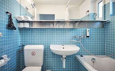 Kompaktes Badezimmer mit Waschbecken, Toilette und Badewanne.