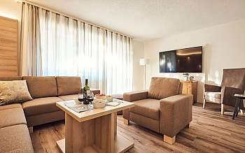 Espace de vie avec canapé, table et télévision.